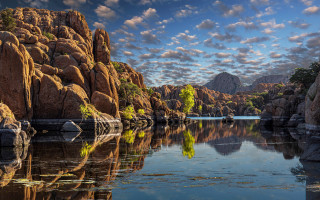 Lake rocks trees cloudy sky 4 - a mountain range in the background free wallpaper