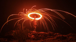 Fire ring night city lights - a person holding free wallpaper