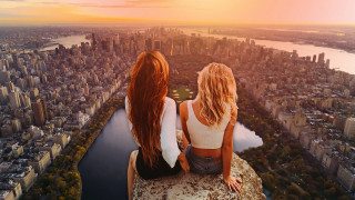 Cityscape sunset two women riverside - daren bader free wallpaper