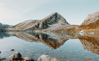 Mountain lake rocks snowy mountains - a clear sky free wallpaper