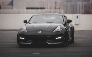 Black sports car parking lot 15 - a white wall behind free wallpaper