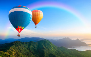 Hot air balloons mountain rainbow - over a mountain range free wallpaper