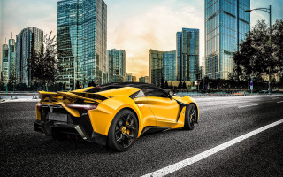 Yellow sports car cityscape night - a yellow sports car free wallpaper