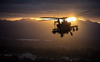 Helicopter sunset mountains clouds lensflare - a helicopter free wallpaper
