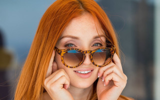 Red haired woman sunglasses smiling - sunglass free wallpaper