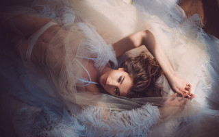 Woman laying white dress feathers - feather free wallpaper