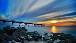 Long pier rocky beach sunset - a long pier free wallpaper