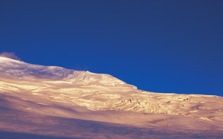 Snowy mountain blue sky clouds 3 - a clear blue sky in the background free wallpaper