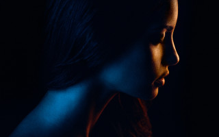 Woman dark background serious look - something free wallpaper