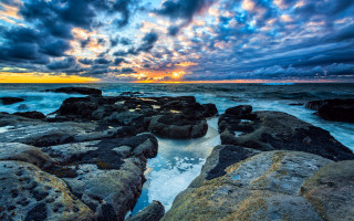 Sunset rocky beach waves clouds 2 - a sunset over a rocky beach free wallpaper