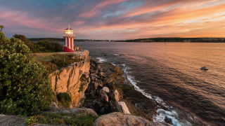 Lighthouse cliff ocean sunset boat 3 - the water below free wallpaper