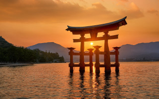Sunset ocean bridge mountains structure - a large body of water free wallpaper