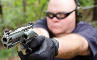 Male aiming gun gloves glasses - round free wallpaper