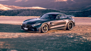Black sports car dirt road 3 - the background and a mountain range in the distance free wallpaper