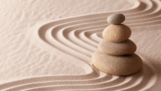 Stacked rocks sandy ground spiral - a stack of rocks free wallpaper