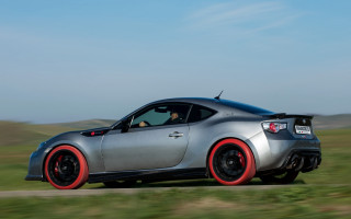 Silver sports car driving grass - a road next free wallpaper
