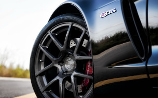 Car tire road sky grass - a close up of a car tire free wallpaper