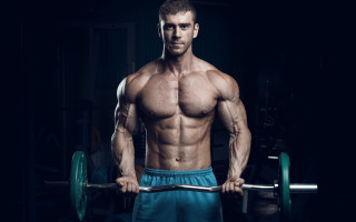 Muscular man barbell dark room - a barbell free wallpaper