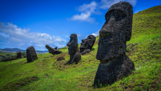 Rocky hilltop green field statue - lush free wallpaper