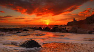 Sunset ocean waves rocks lighthouse 3 - a lighthouse in the distance free wallpaper