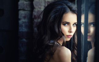 Woman window brick wall blue - a brick wall behind her free wallpaper