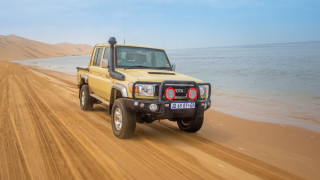 Yellow truck dirt road ocean - a yellow truck free wallpaper