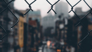 Wet city street rain fence - a city street in the background free wallpaper