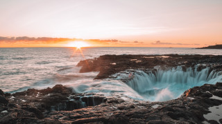 Sunset ocean rocks lake mountain - a large body of water free wallpaper