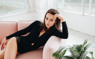 Woman black dress pink couch - private press free wallpaper