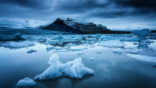 Icebergs lake mountains cloudy sky - a group of icebergs free wallpaper