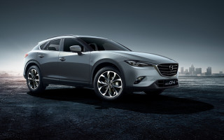 Silver mazda city skyline night - a city skyline in the background free wallpaper