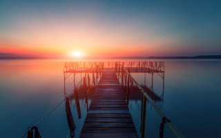 Dock sunset water gradient sky - a dock in the foreground free wallpaper