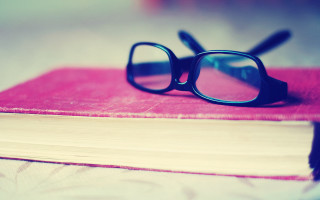 Glasses on book outdoor beach - a pair of glasses free wallpaper