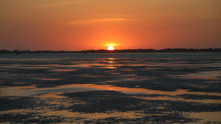 Sunset water boat clouds horizon 6 - a boat in the distance free wallpaper