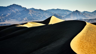 Desert yellow sand dune mountains - the background and a sky line in the foreground free wallpaper