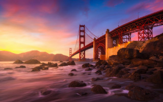 Bridge rocks sunset mountain water - a bridge over a body of water free wallpaper