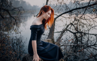 Woman red hair lake portrait - a tree branch in the foreground free wallpaper