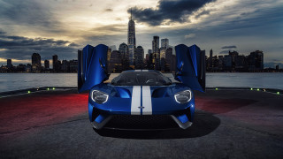 Blue sports car city skyline - a blue sports car free wallpaper for desktop