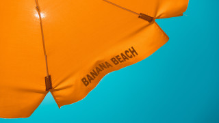 Orange umbrella banana beach blue - a blue sky background free wallpaper