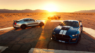 Desert cars sunset mountains tiltshift - the sun setting behind them free wallpaper