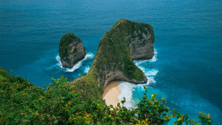 Large rocks green hillside ocean - sandy free wallpaper