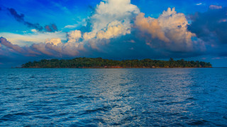 Small island ocean cloudy sky - the water below free wallpaper