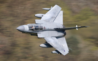 Fighter jet aircraft military pilot - a blurry background of trees and bushes free wallpaper