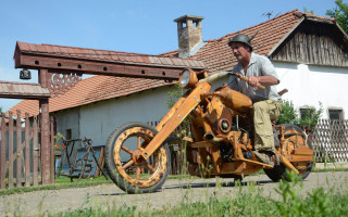 Man motorcycle house red roof - a woodcut free wallpaper