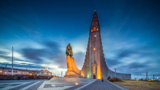 Large building tall tower nighttime 2 - a statue of a man free wallpaper