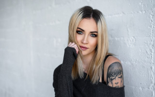 Woman tattoo portrait black blonde - a white wall behind her free wallpaper