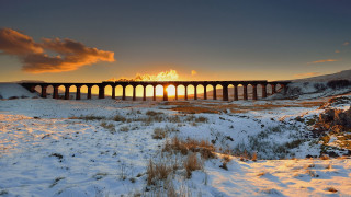 Train bridge snowy field sunset - a sunset in the background free wallpaper