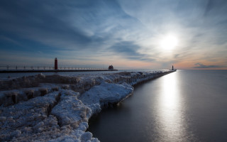 Lighthouse pier snow ice sun - a bright sun in the background free wallpaper
