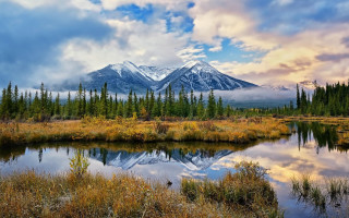 Mountain lake forest cloudy sky 5 - a lake in the foreground and trees free wallpaper