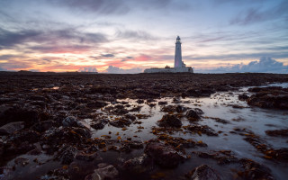 Lighthouse rocky shore sunset clouds 17 - a rocky shore free wallpaper